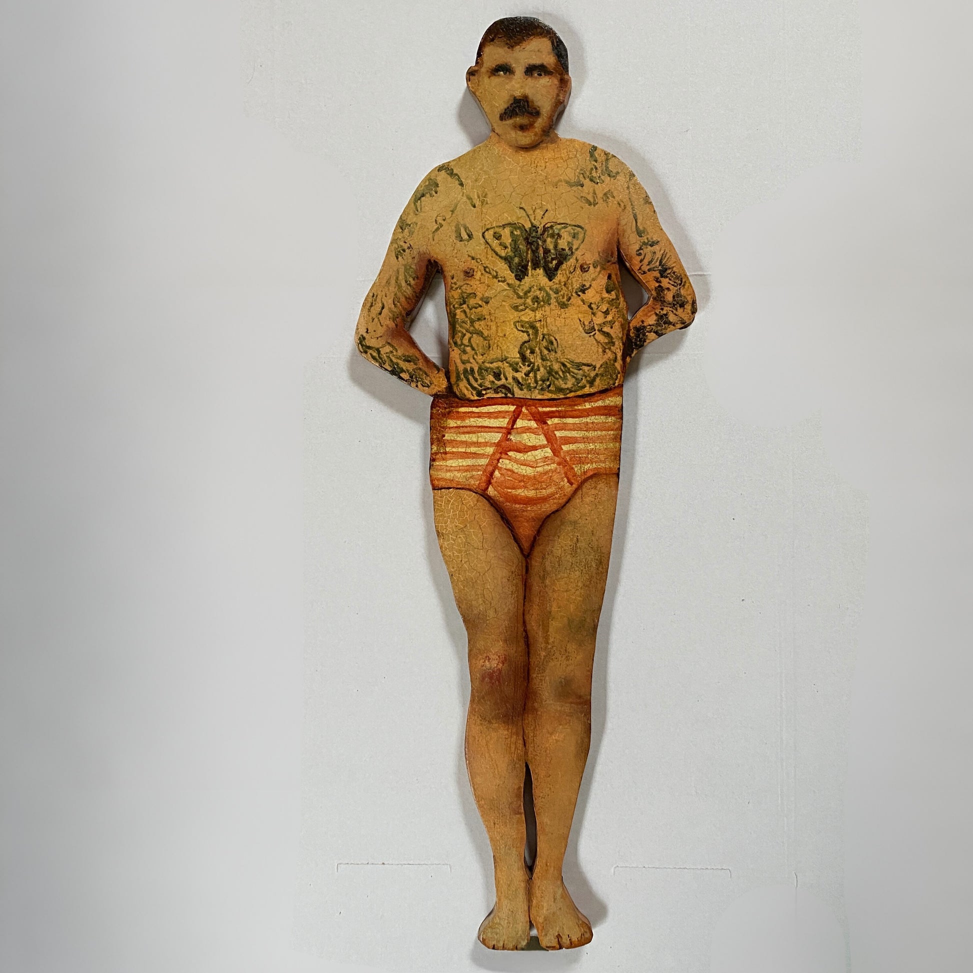 Papillon Man original oil painting on bespoke wood panel, butterfly-themed outsider art with dual-sided narrative, here he's wearing a red and white pants on a white background.